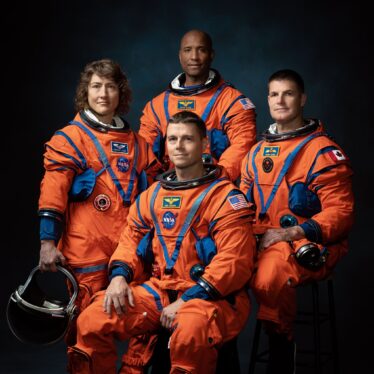 NASA astronauts sign their moon rocket