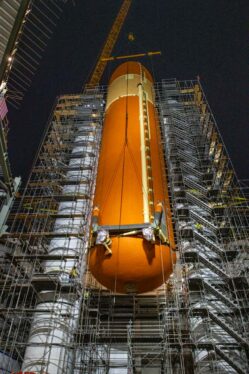Space Shuttle’s Massive Tank Hoisted Atop Rocket Boosters for Historic Display